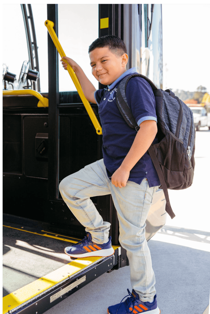Boy getting on bus