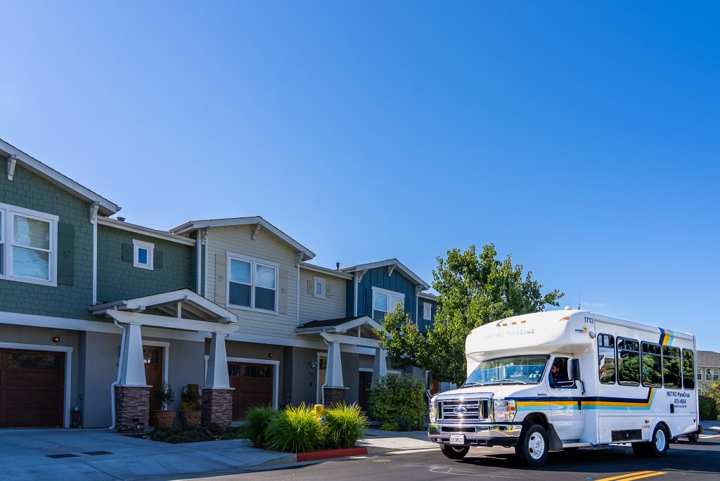 ParaCruz shuttle parked in front of a row of houses