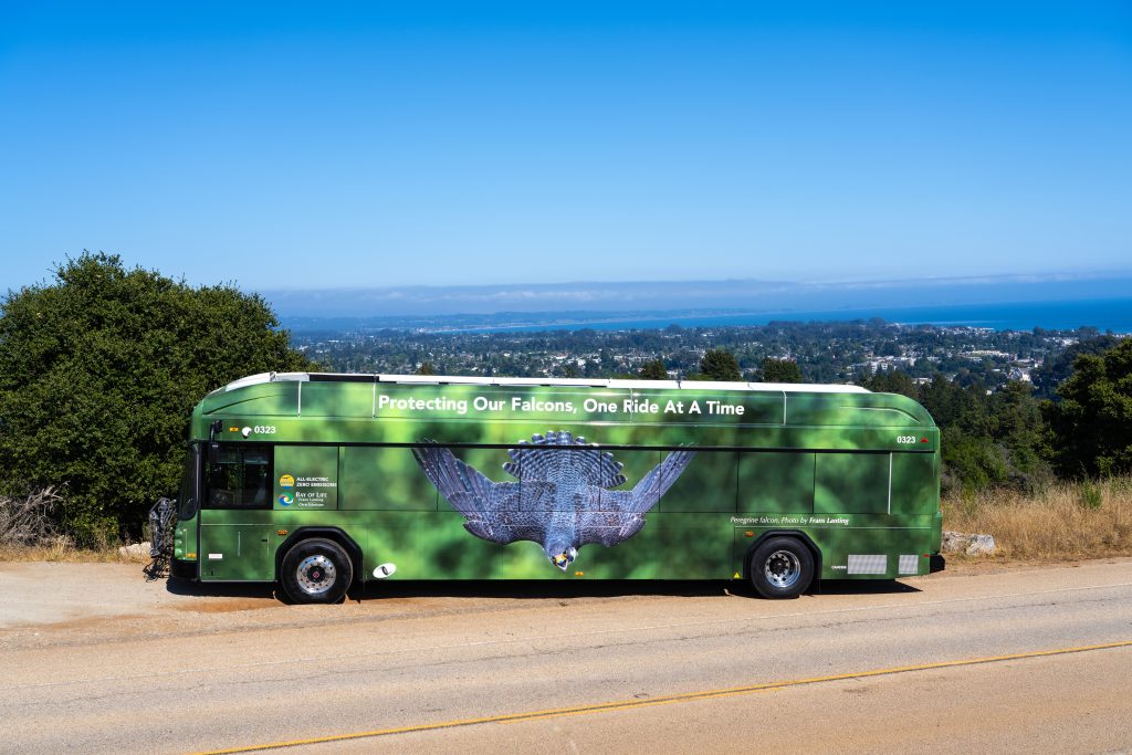 Peregrine Falcon Bus parked at UCSC Coolidge Drive Lookout overlooking Santa Cruz with ocean in the background