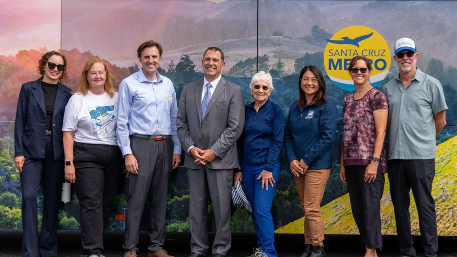 SC METRO employees and volunteers standing in front of a METRO bus.